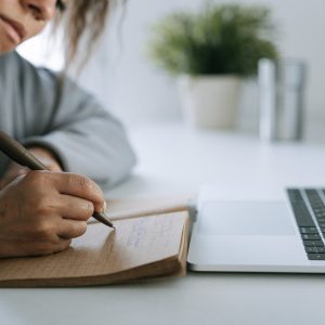 woman writing on a notebook