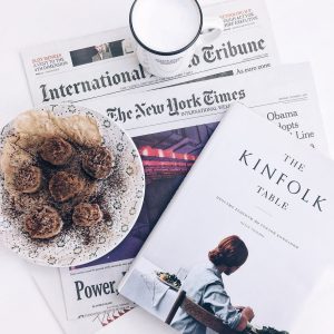 the kinfolk table book beside baked pastry on white ceramic plate with white ceramic mug