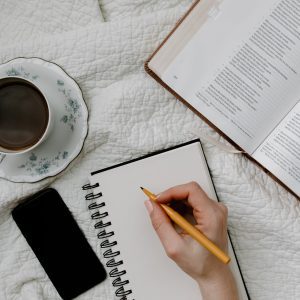 a person writing in the notebook