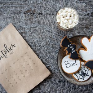 bowl of halloween cookies on gray textile