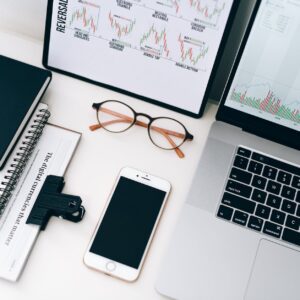 laptop beside eyeglasses and smartphone