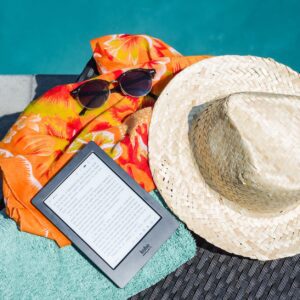 black amazon kindle tablet near brown drawstring sun hat