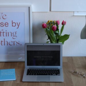 desk with opened laptop book and lamp