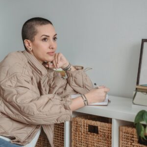 author with diary leaning on table at home