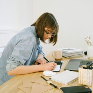 woman writing on a notebook