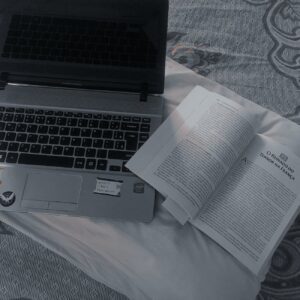 book beside a laptop