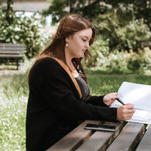 woman correcting information in paper with pen