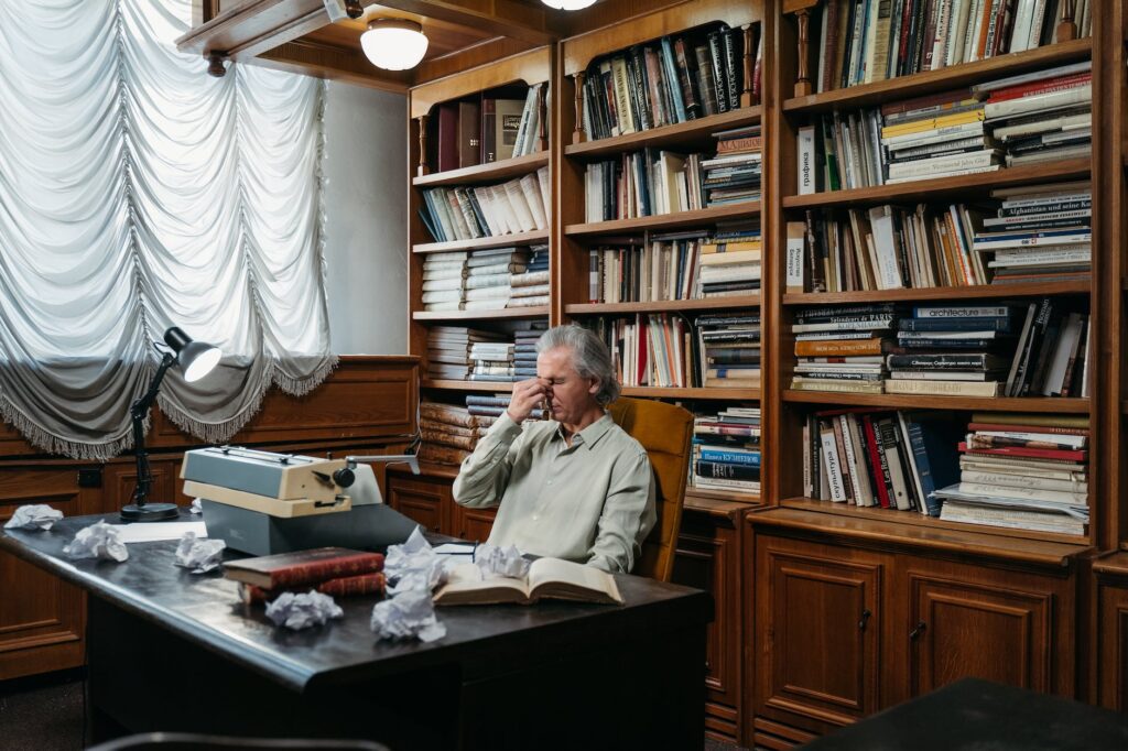 a man sitting behind his desk