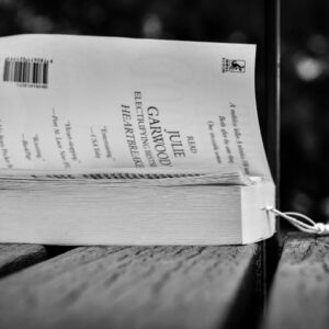 opened book placed on wooden table in park