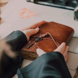 a person holding brown book