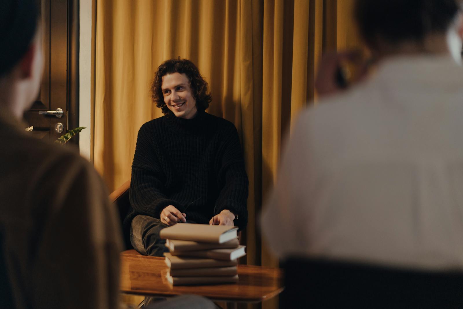 A writer discusses his book with an audience during a creative evening at a cozy bookstore.